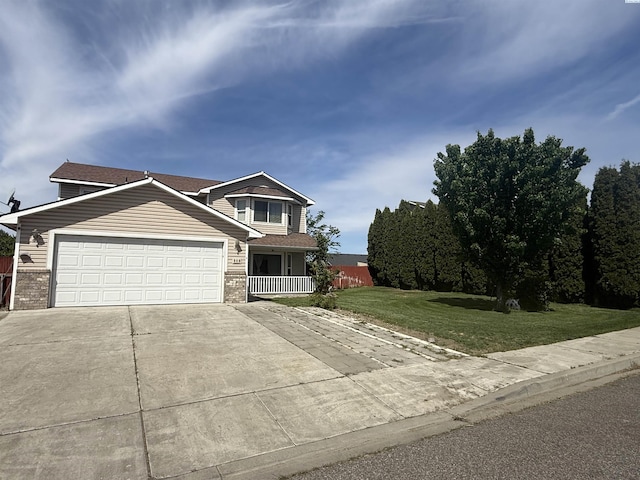 808 N Owen Ave, Pasco, WA 99301 - view of front facade featuring a front yard, driveway, brick siding, and an attached garage