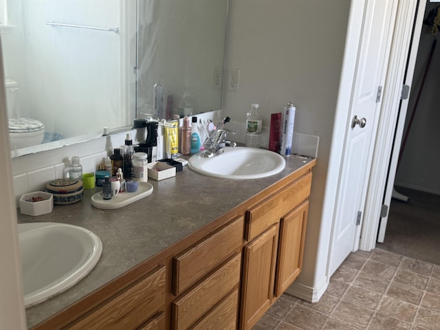 808 N Owen Ave, Pasco, WA 99301 - full bathroom with double vanity, stone finish floors, and toilet