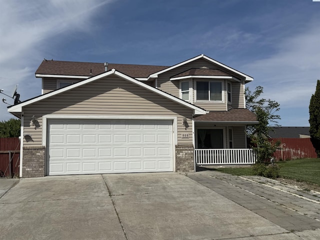 808 N Owen Ave, Pasco, WA 99301 - view of front of property with concrete driveway, a garage, and covered porch