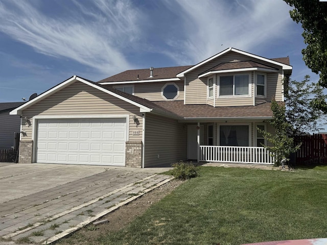 808 N Owen Ave, Pasco, WA 99301 - view of front of home featuring covered porch, concrete driveway, an attached garage, brick siding, and roof with shingles
