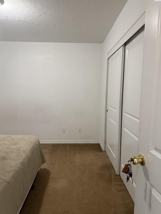 808 N Owen Ave, Pasco, WA 99301 - bedroom with dark carpet, baseboards, and a closet