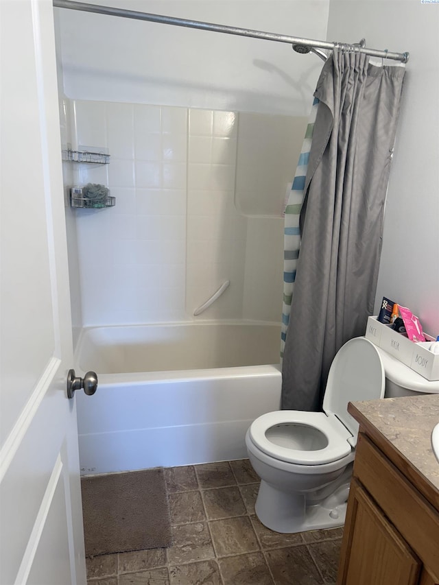 808 N Owen Ave, Pasco, WA 99301 - bathroom featuring toilet, shower / tub combo with curtain, vanity, and stone tile flooring