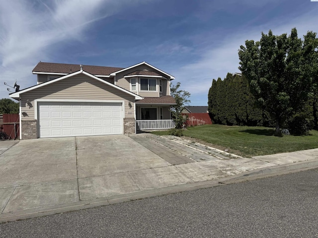 808 N Owen Ave, Pasco, WA 99301 - view of front facade with concrete driveway, a garage, brick siding, and covered porch