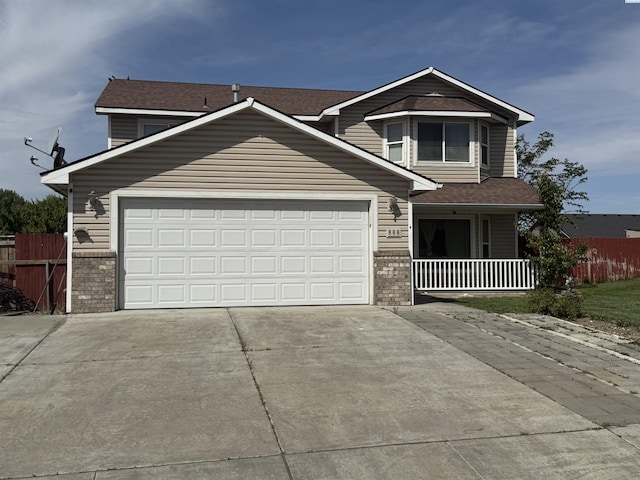 808 N Owen Ave, Pasco, WA 99301 - traditional-style house with driveway, a garage, brick siding, and covered porch