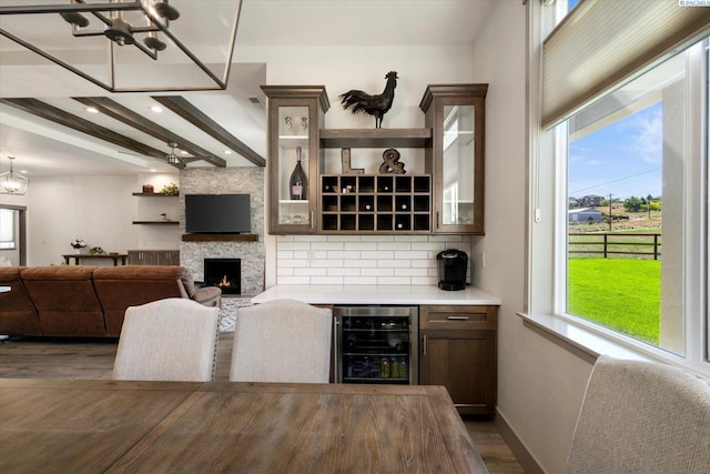 3905 Orchard St, West Richland, WA 99353 - bar featuring beverage cooler, dark wood-style flooring, plenty of natural light, a chandelier, and beamed ceiling
