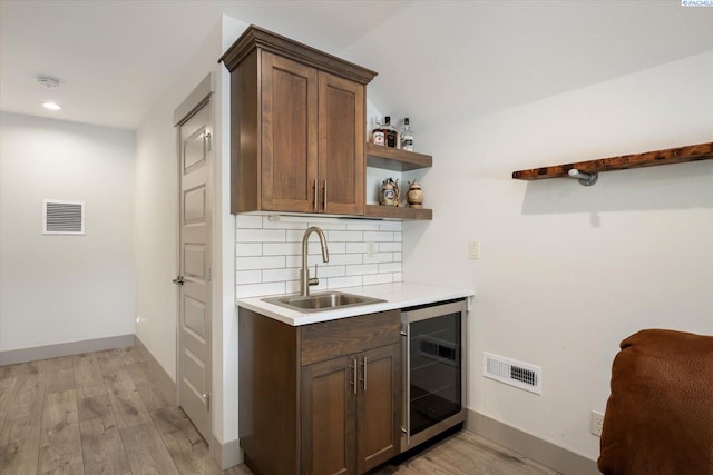3905 Orchard St, West Richland, WA 99353 - indoor wet bar featuring beverage cooler, light wood finished floors, backsplash, baseboards, and recessed lighting