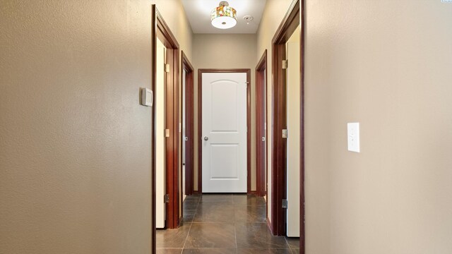 corridor with dark tile patterned flooring