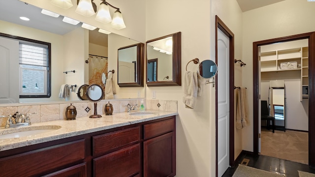 full bath featuring double vanity and a sink