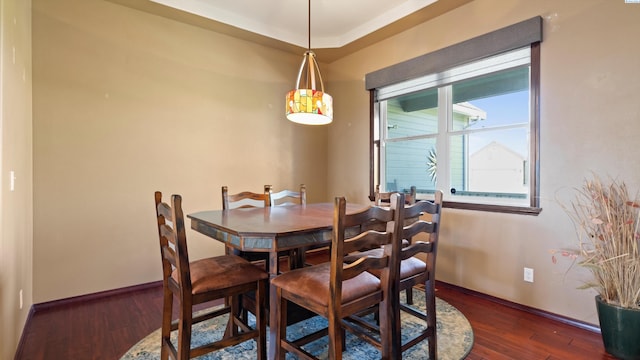 dining space with wood finished floors and baseboards