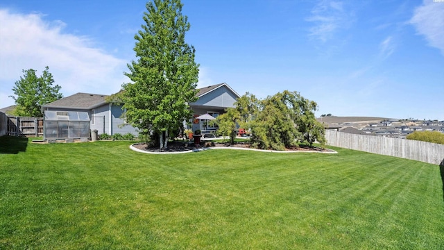 view of yard with fence, an outdoor structure, and a greenhouse