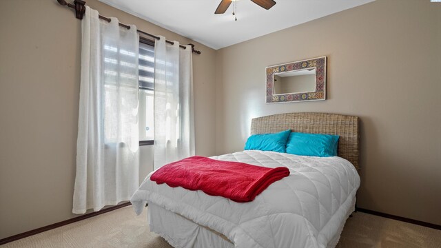 carpeted bedroom featuring ceiling fan and baseboards