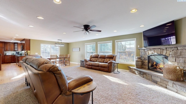 living room with a fireplace and ceiling fan