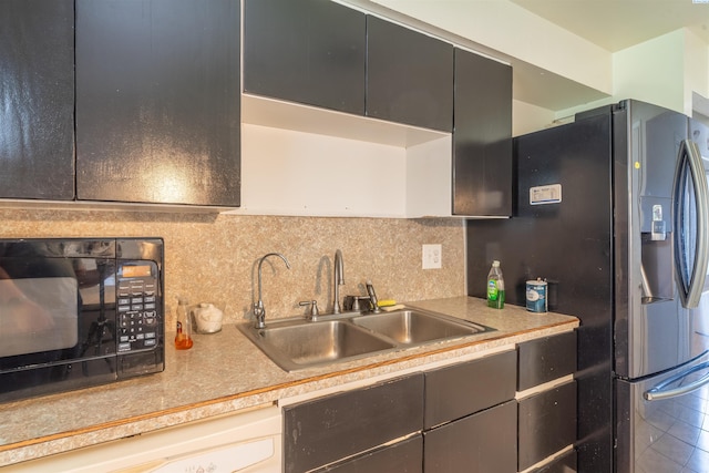 775 S 4th Ave, Othello, WA 99344 - kitchen with a sink, black microwave, backsplash, and light countertops