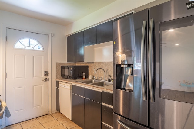775 S 4th Ave, Othello, WA 99344 - kitchen featuring stainless steel refrigerator with ice dispenser, black microwave, a sink, white dishwasher, and light tile patterned floors