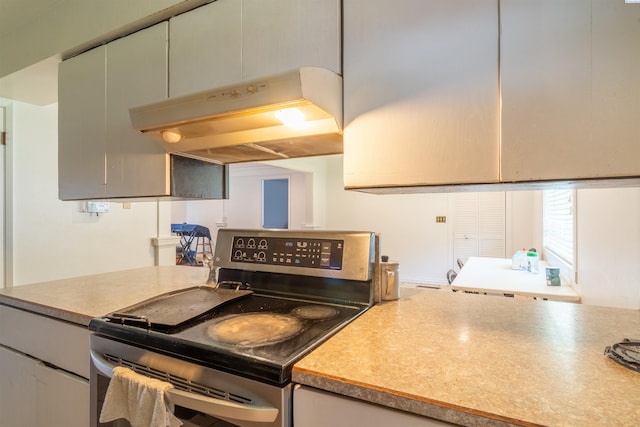 775 S 4th Ave, Othello, WA 99344 - kitchen featuring electric stove, light countertops, and under cabinet range hood