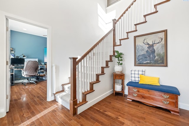 stairway with hardwood / wood-style flooring and baseboards