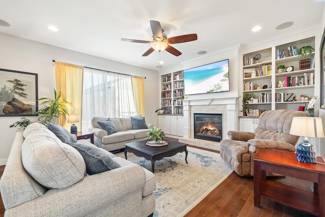 living room featuring dark wood-type flooring, a glass covered fireplace, a ceiling fan, and recessed lighting