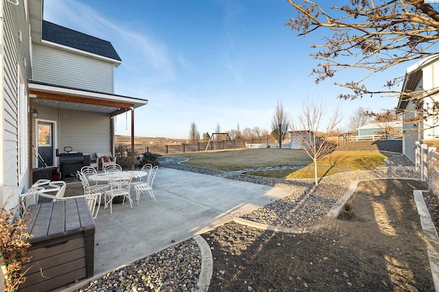 view of yard with outdoor dining space, a patio area, and a fenced backyard