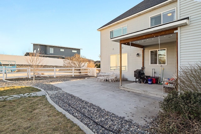 rear view of house with a patio and fence