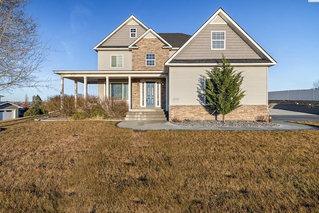 craftsman-style home with stone siding and a front lawn