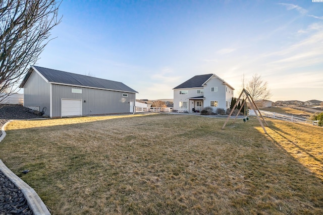 view of yard featuring fence, an outbuilding, and an outdoor structure