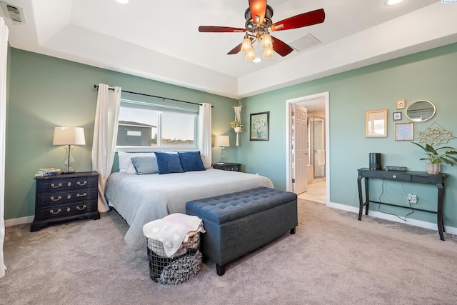 bedroom with visible vents, baseboards, a raised ceiling, and carpet flooring