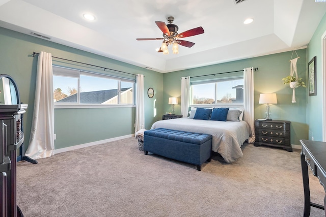 bedroom featuring baseboards, visible vents, a raised ceiling, and carpet flooring