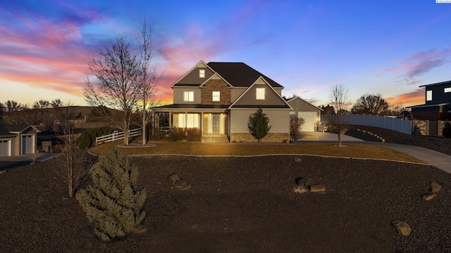 view of front of house featuring driveway and fence