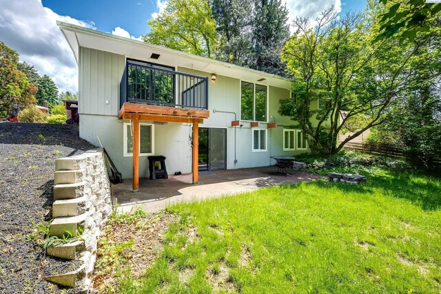 1315 NW Haven Cir, Pullman, WA 99163 - back of house featuring a balcony, a patio area, and a lawn