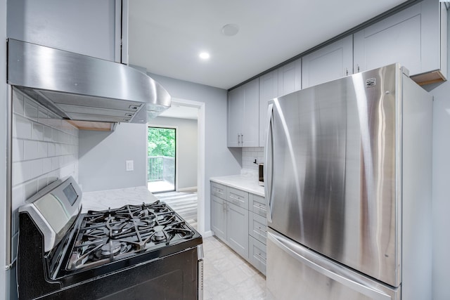 1315 NW Haven Cir, Pullman, WA 99163 - kitchen with appliances with stainless steel finishes, wall chimney range hood, gray cabinetry, decorative backsplash, and light stone countertops