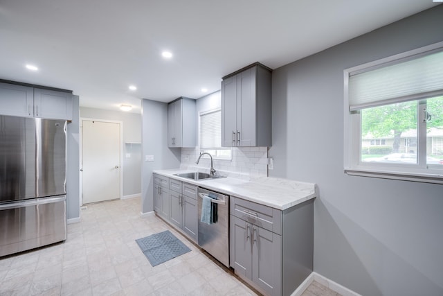 1315 NW Haven Cir, Pullman, WA 99163 - kitchen with stainless steel appliances, a sink, gray cabinetry, decorative backsplash, and baseboards