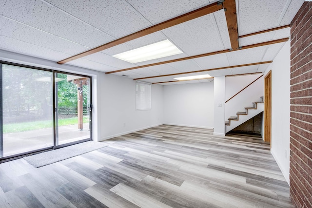 1315 NW Haven Cir, Pullman, WA 99163 - basement with light wood finished floors, stairway, brick wall, and baseboards