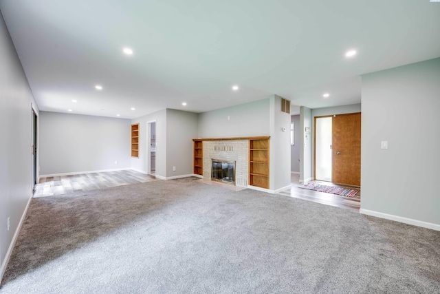 1315 NW Haven Cir, Pullman, WA 99163 - unfurnished living room with carpet flooring, baseboards, recessed lighting, and a brick fireplace