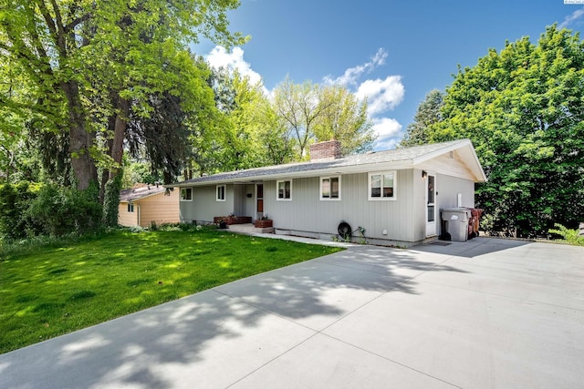 1315 NW Haven Cir, Pullman, WA 99163 - ranch-style home with a chimney, driveway, and a front lawn