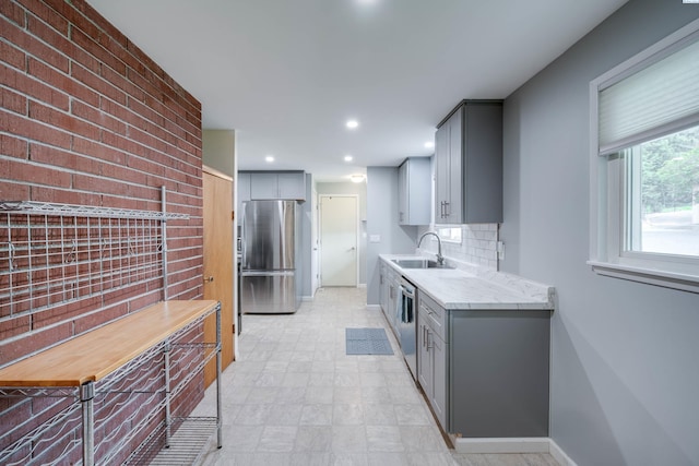 1315 NW Haven Cir, Pullman, WA 99163 - kitchen with gray cabinets, stainless steel appliances, a sink, tasteful backsplash, and recessed lighting