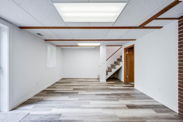 1315 NW Haven Cir, Pullman, WA 99163 - finished below grade area with stairs, wood finished floors, a paneled ceiling, and baseboards