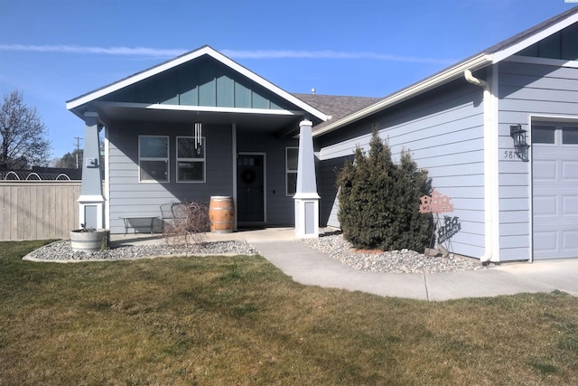 view of front of home with a garage, fence, and a front lawn