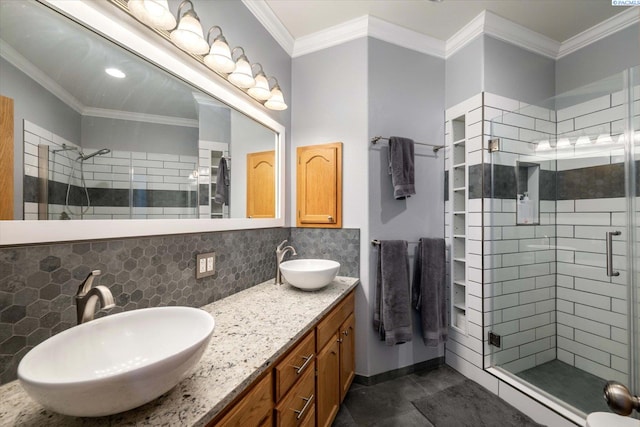 521 Eastgate Dr, Prosser, WA 99350 - full bathroom featuring a stall shower, double vanity, decorative backsplash, and crown molding