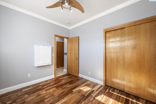 521 Eastgate Dr, Prosser, WA 99350 - unfurnished bedroom with wood finished floors, crown molding, baseboards, a closet, and ceiling fan