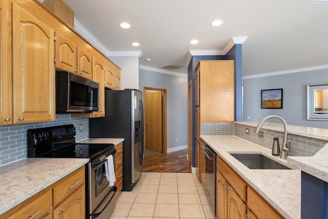 521 Eastgate Dr, Prosser, WA 99350 - kitchen featuring stainless steel appliances, a sink, light stone countertops, ornamental molding, and backsplash