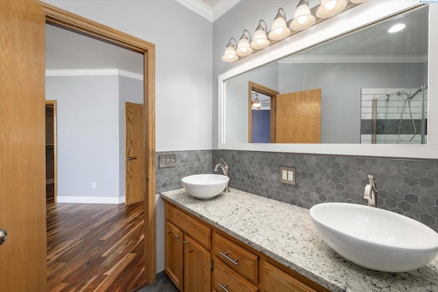 521 Eastgate Dr, Prosser, WA 99350 - full bath with wood finished floors, decorative backsplash, ornamental molding, double vanity, and baseboards