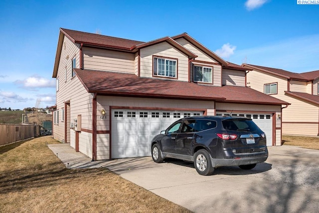 573-575 SE Shoemaker Pl, Pullman, WA 99163 - view of front of home with driveway, an attached garage, a shingled roof, and a front yard