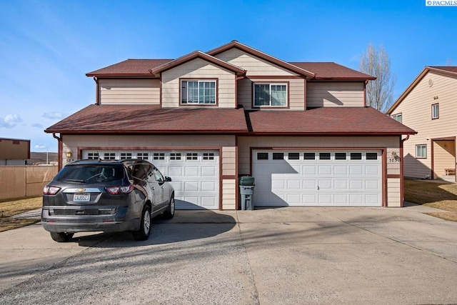 573-575 SE Shoemaker Pl, Pullman, WA 99163 - view of front of property with concrete driveway, an attached garage, and roof with shingles