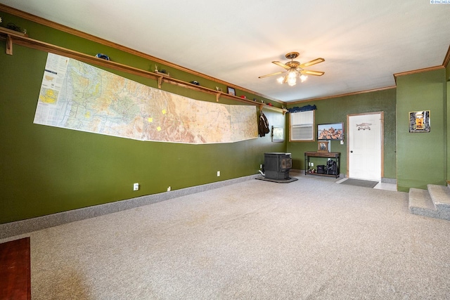 4016 W Ruby, Pasco, WA 99301 - unfurnished living room featuring a wood stove, ornamental molding, carpet floors, and ceiling fan