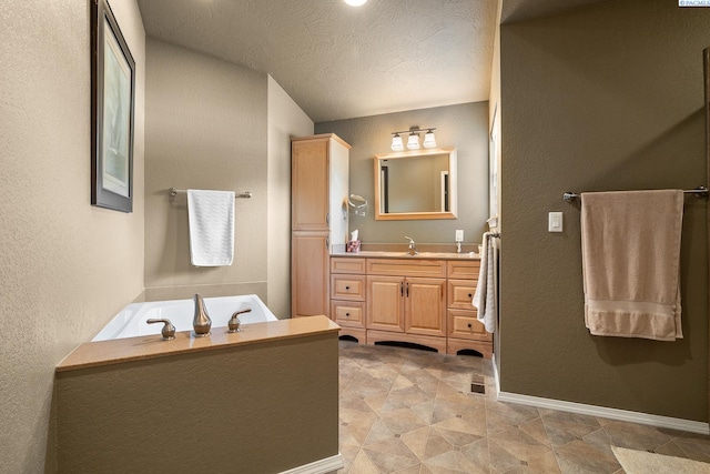 4016 W Ruby, Pasco, WA 99301 - bathroom with vanity, a garden tub, a textured wall, and a textured ceiling