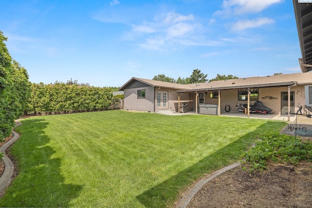 4016 W Ruby, Pasco, WA 99301 - view of green lawn with a hot tub, french doors, and a patio area