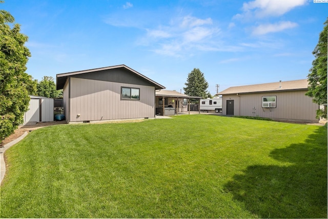 4016 W Ruby, Pasco, WA 99301 - rear view of house featuring a lawn, a storage unit, and crawl space