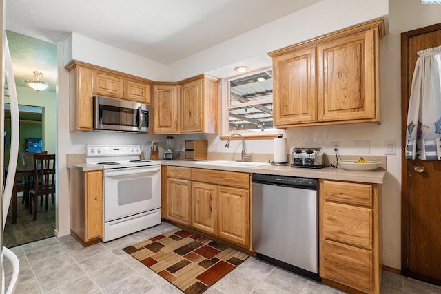 4016 W Ruby, Pasco, WA 99301 - kitchen featuring appliances with stainless steel finishes, light countertops, and light tile patterned floors