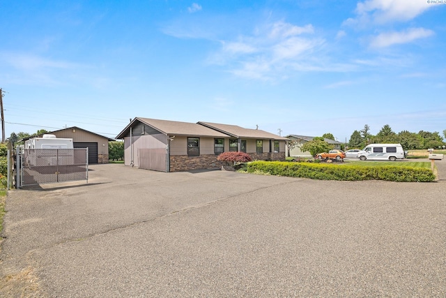 4016 W Ruby, Pasco, WA 99301 - view of front of property with a garage, an outbuilding, and stone siding