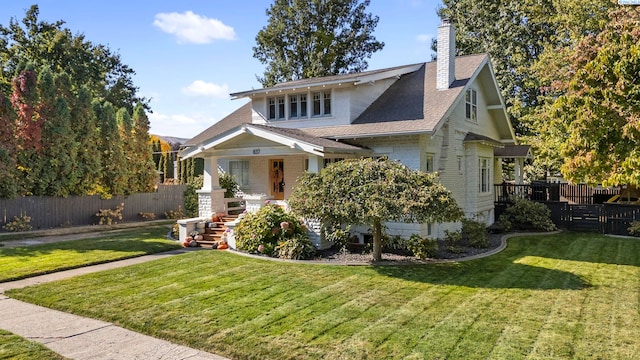 view of front of home featuring covered porch and a front lawn